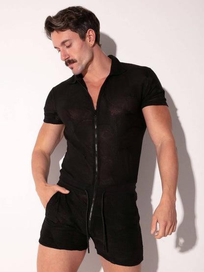 Man wearing a sheer black romper against a white background