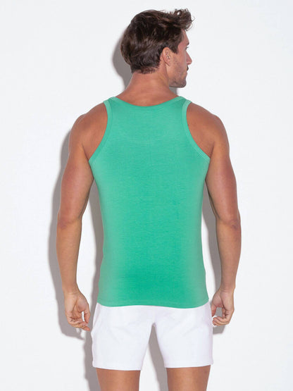 Man wearing a green tank top and white shorts on a white background