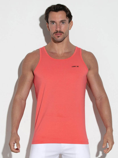 Man wearing a red tank top against a white background