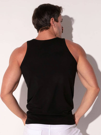 Man wearing a black tank top against a white background
