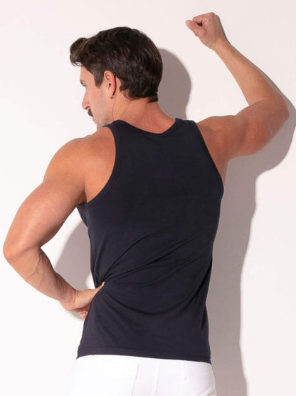 Man wearing a black tank top against a white background