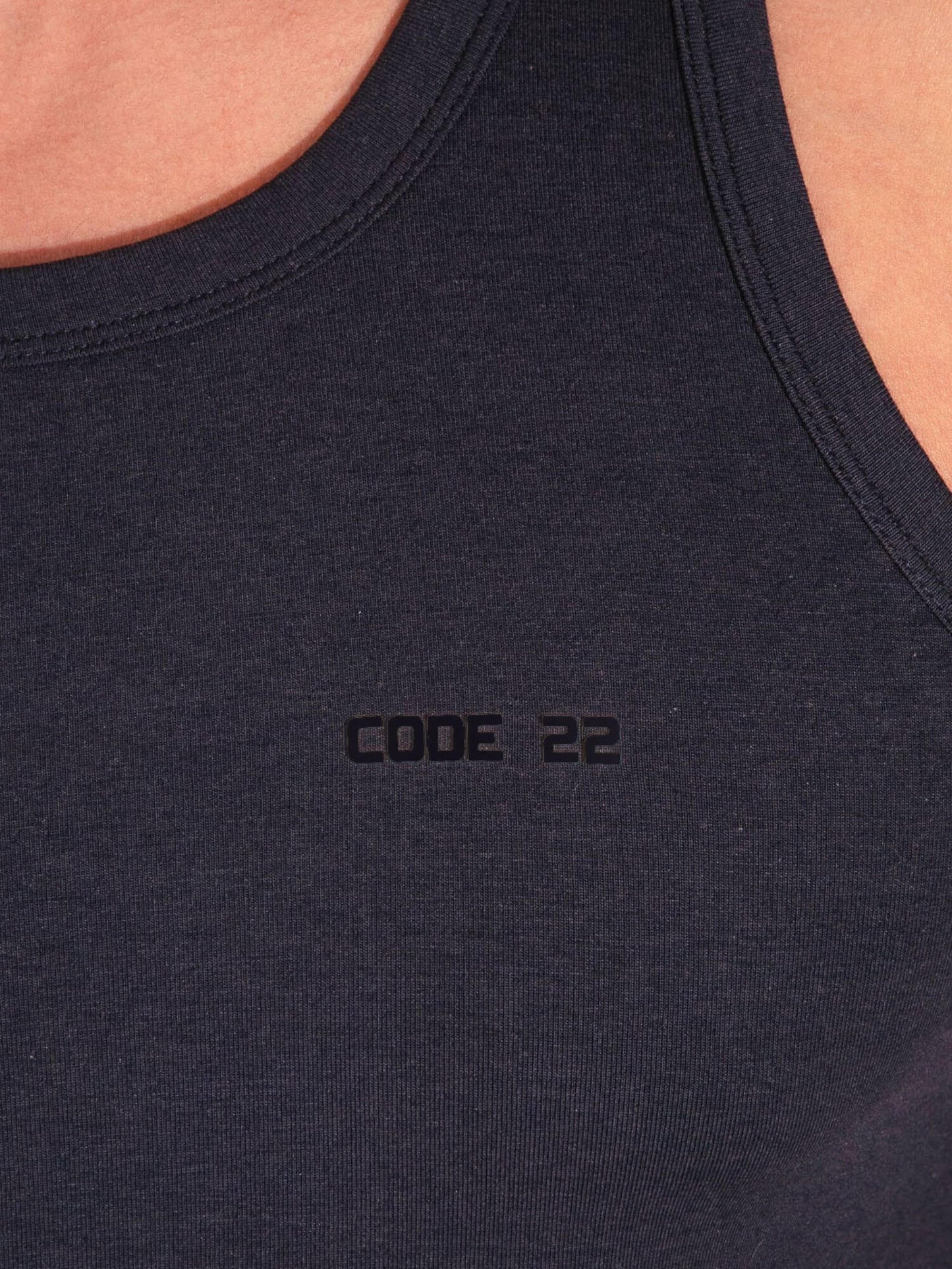 Black tank top with 'CODE 22' logo on a person wearing it.