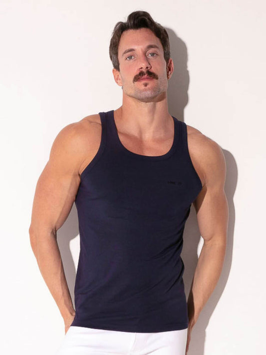 Man wearing a navy tank top against a white background