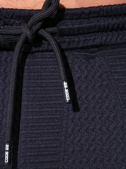 Navy blue jogger pants with drawstring and 'Code 22' branding on a matching tag.