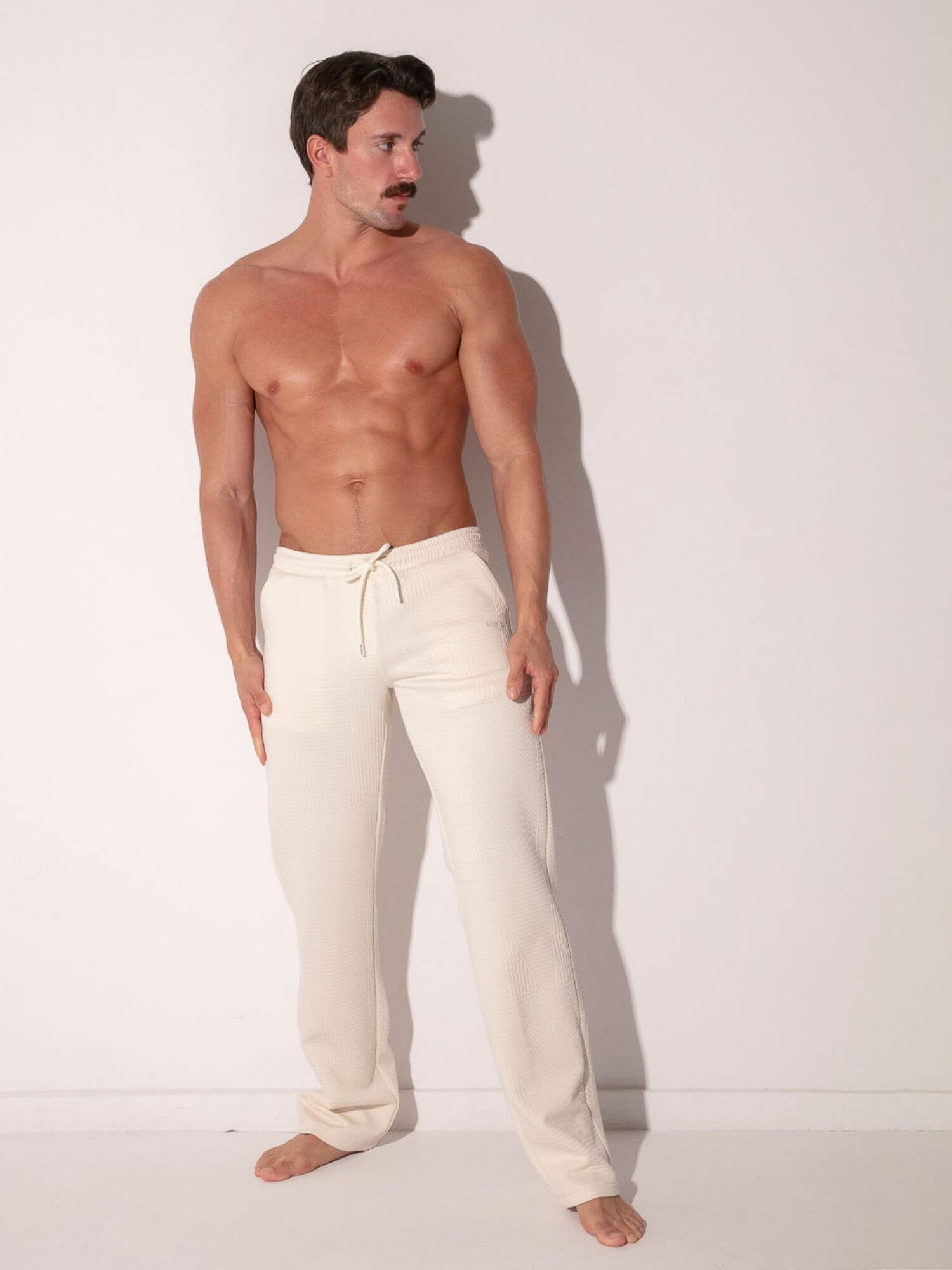 man wearing off-white code 22 medley tank top and pants