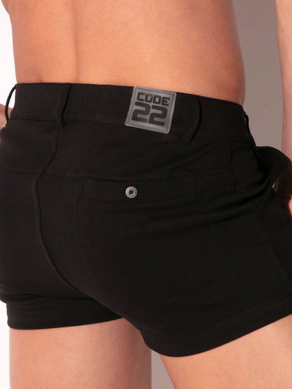 Black shorts with a visible brand label on a neutral background