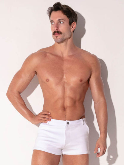 Man wearing white shorts against a plain background