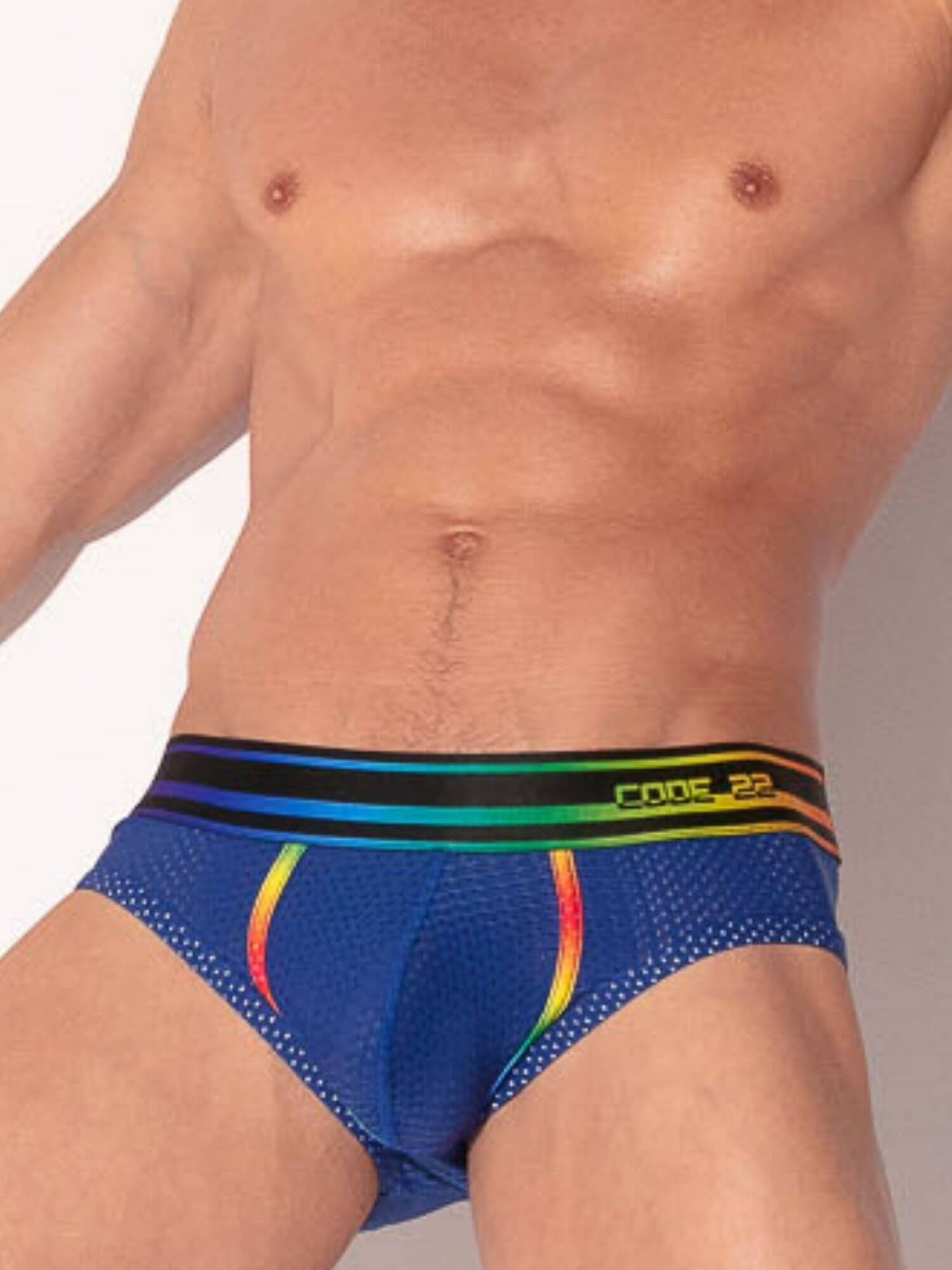 man wearing navy mesh underwear with rainbow striped waistband 
