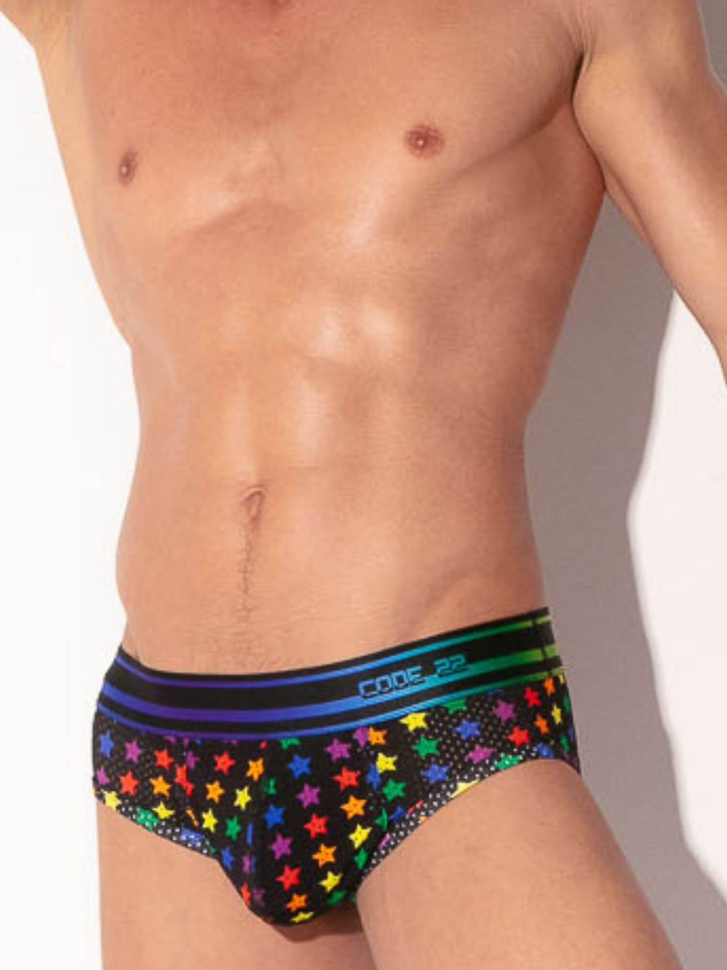 Man wearing colorful star-patterned underwear with a plain background