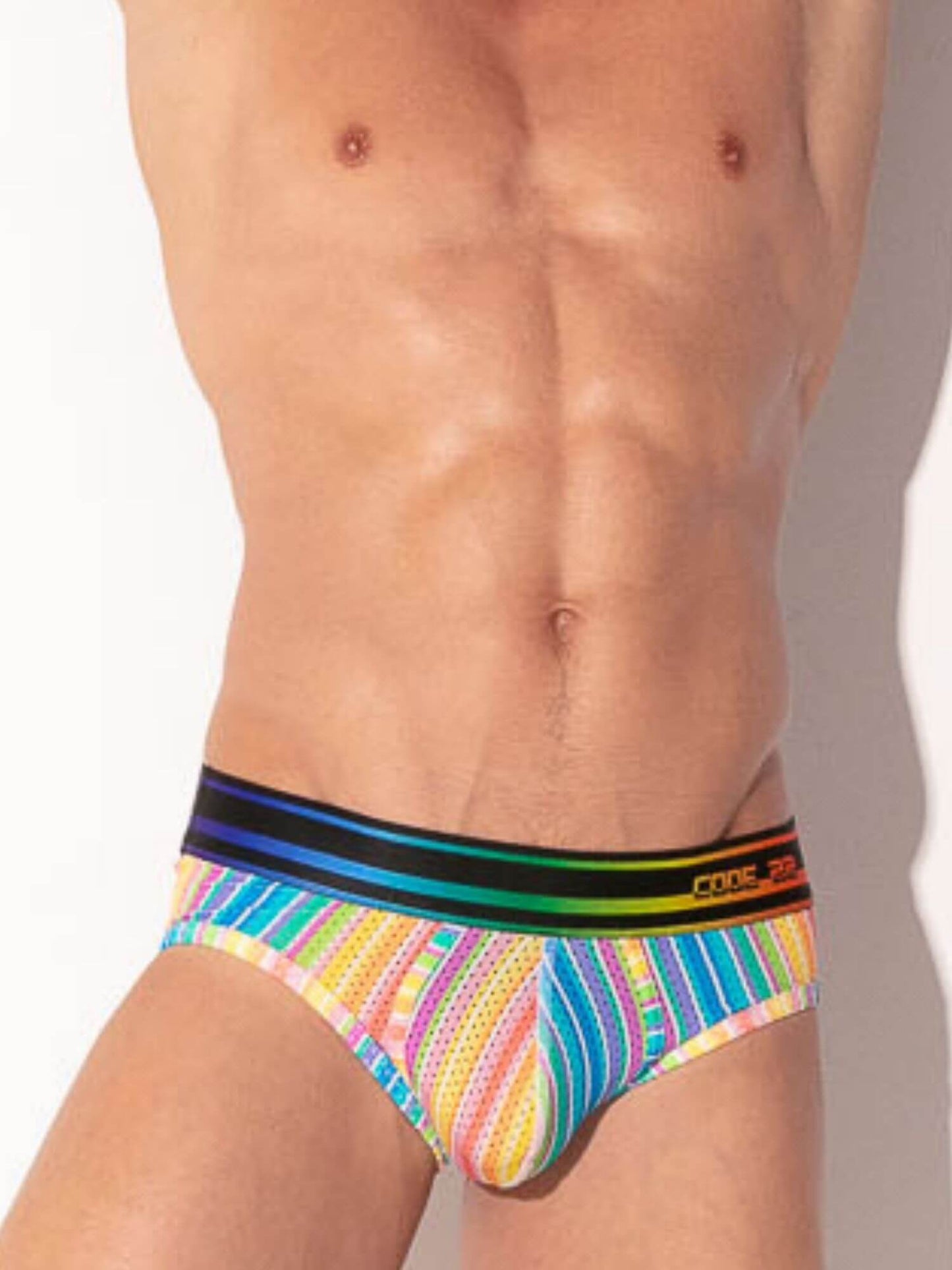 Multicolored men's underwear with a striped waistband on a plain background