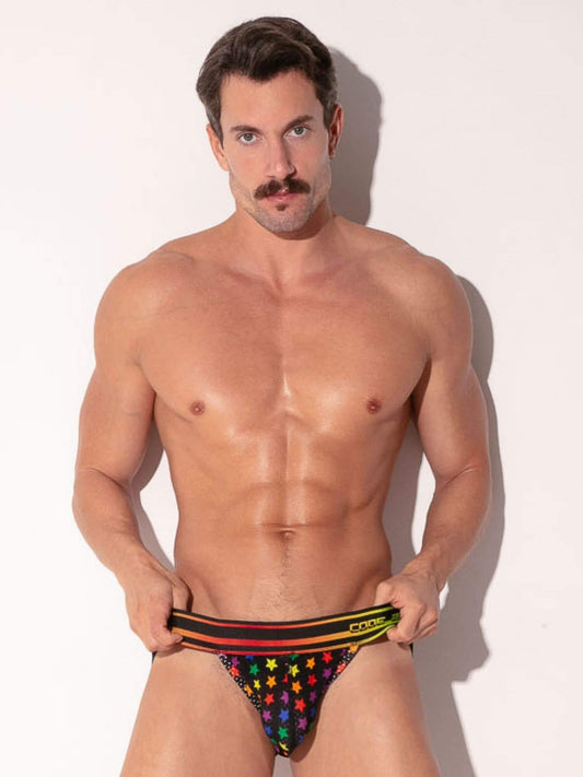 Man holding a colorful star-patterned jock against a white background