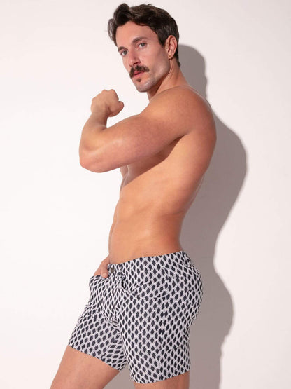 Man wearing patterned pocket shorts against a plain background