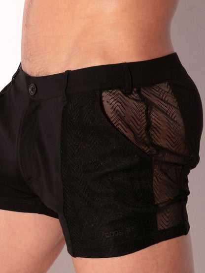 Black athletic shorts with mesh panels on a neutral background