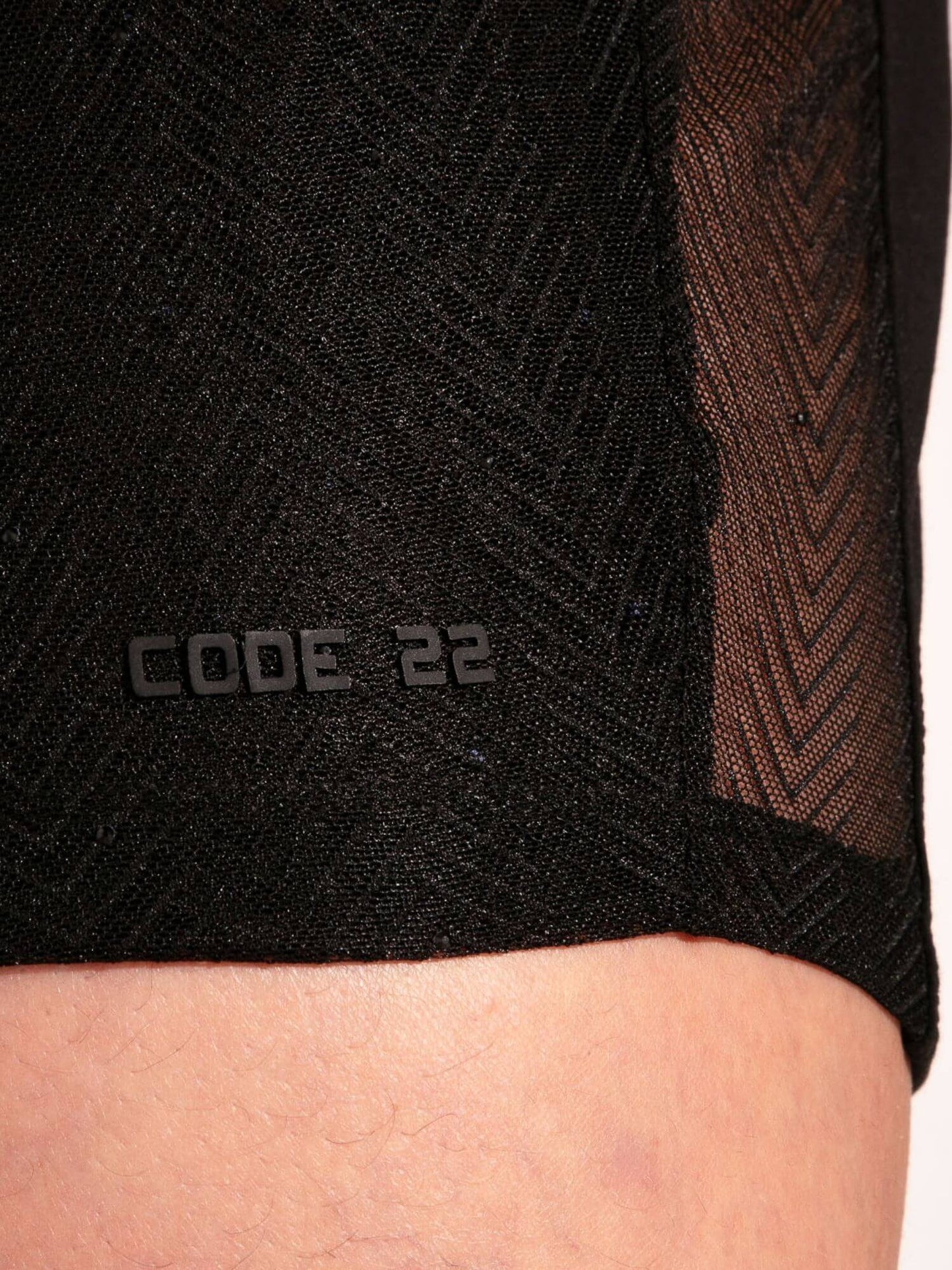 Black athletic shorts with 'CODE 22' branding on a person wearing them.