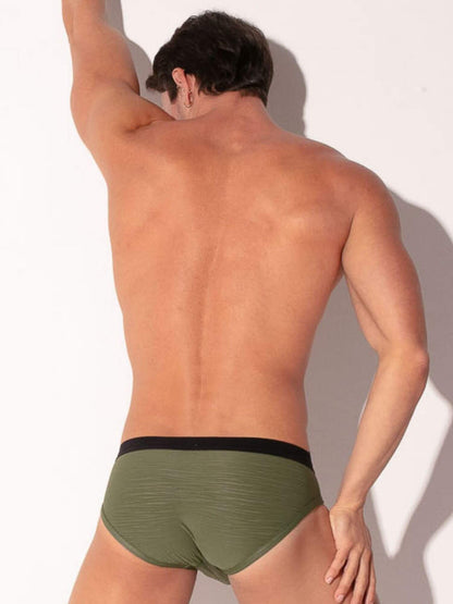 Man wearing green underwear against a white background