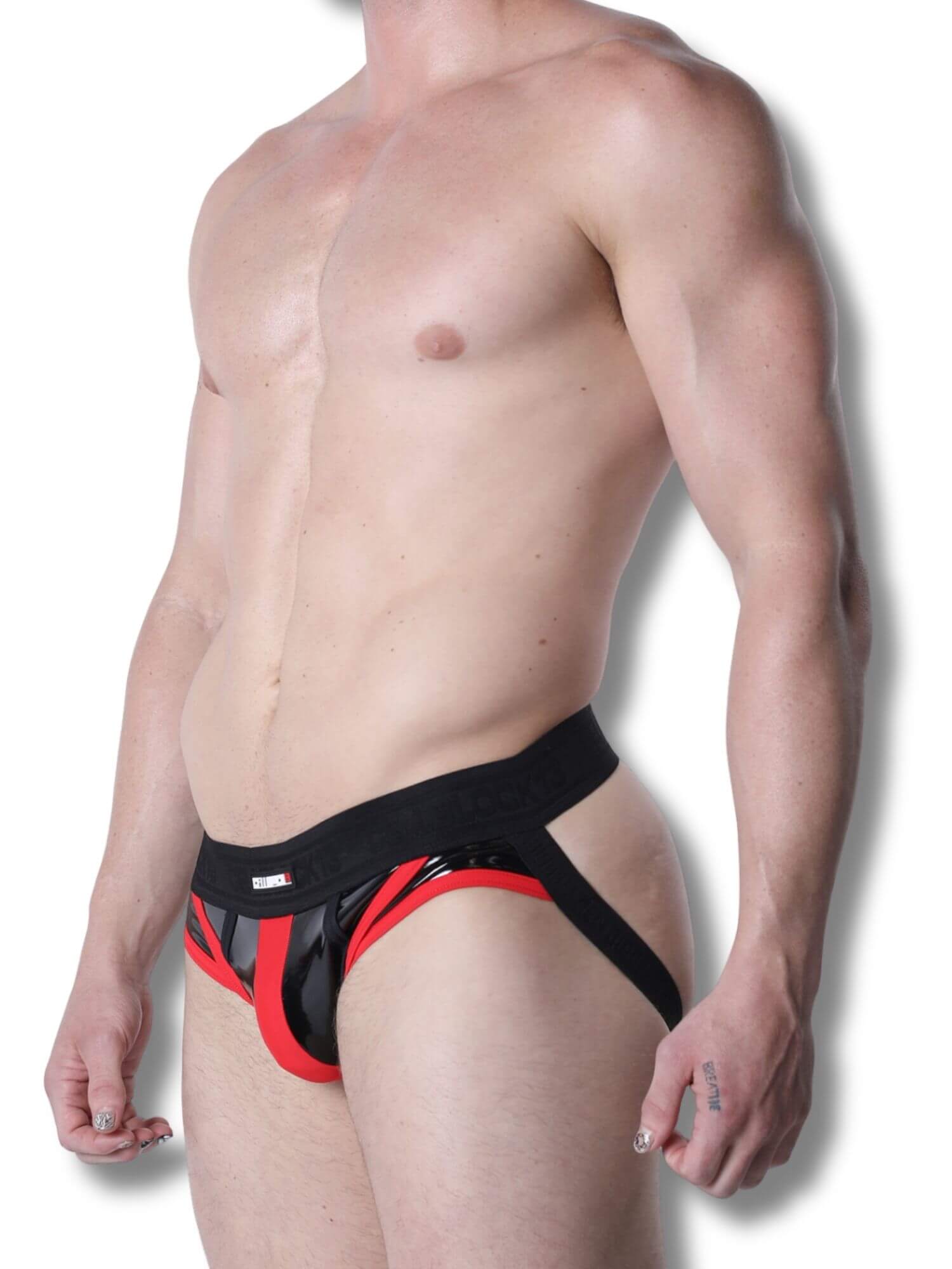 Man wearing a black and red jockstrap on a white background