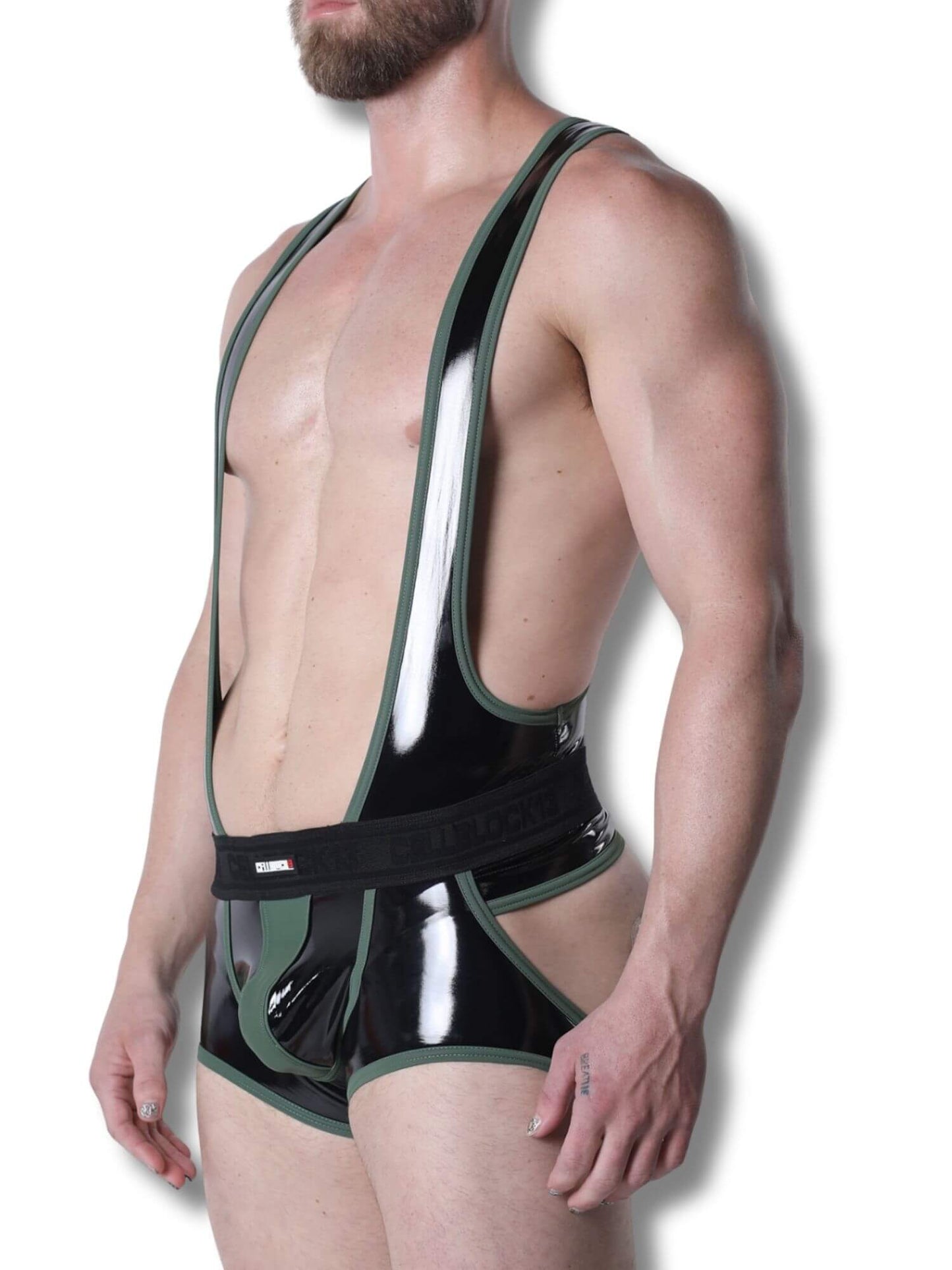 Man wearing a black and green latex outfit against a white background