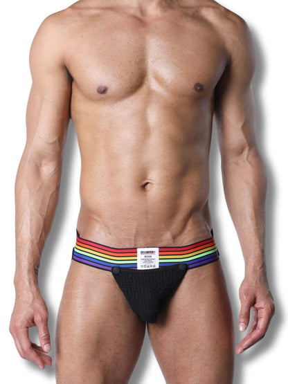 Man wearing a black jockstrap with rainbow stripes on a white background