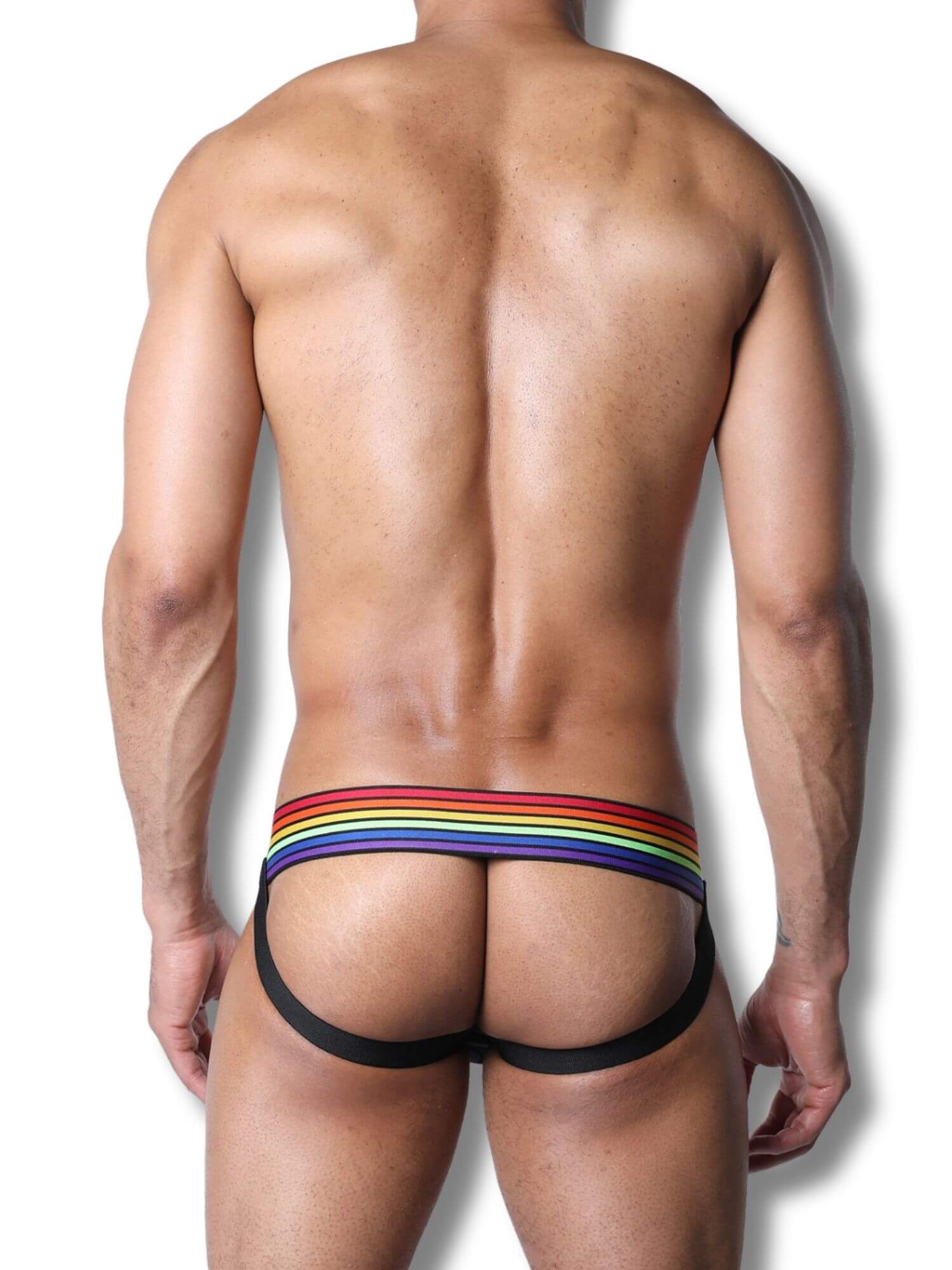 Man wearing a colorful rainbow striped underwear on a white background