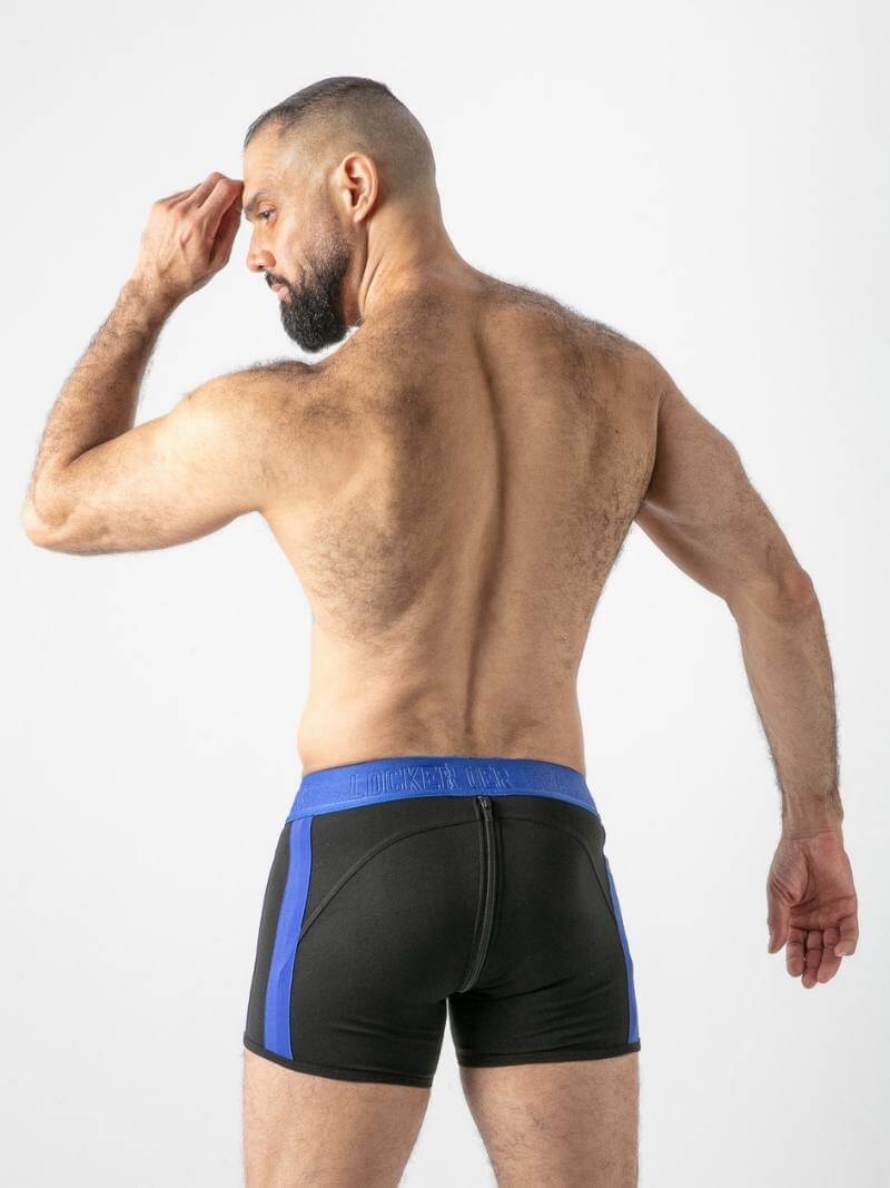 Man wearing black boxer briefs with blue waistband on a white background