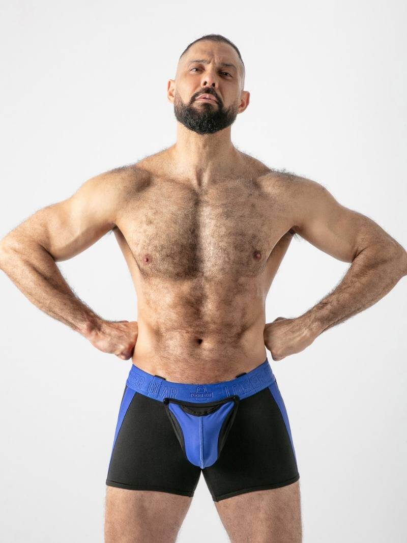 Man wearing black and blue athletic shorts on a white background