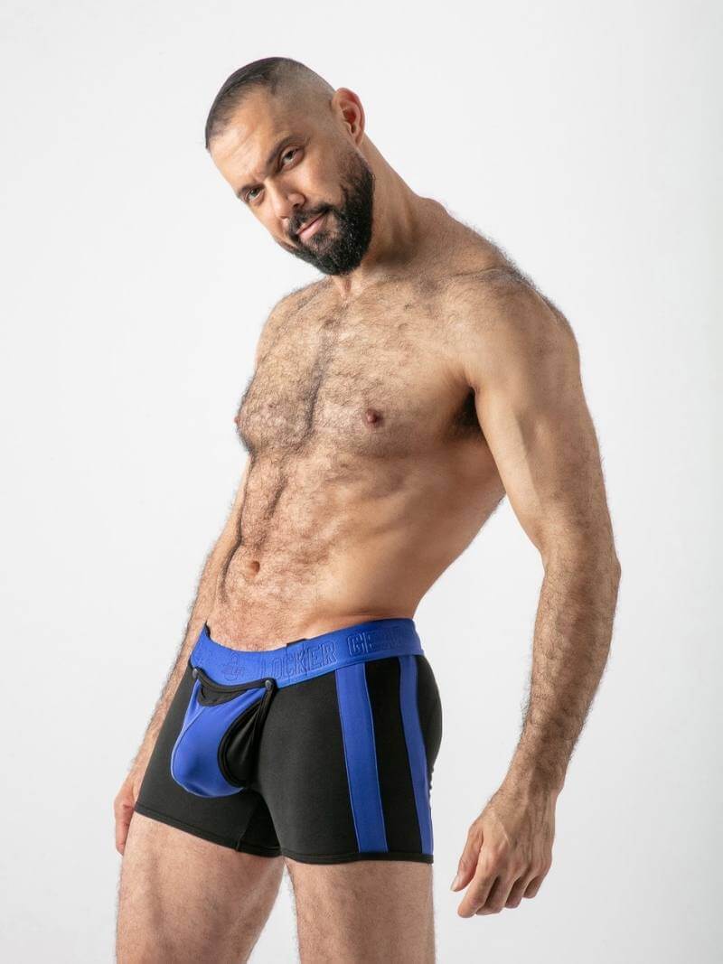 Man wearing black and blue athletic shorts on a white background