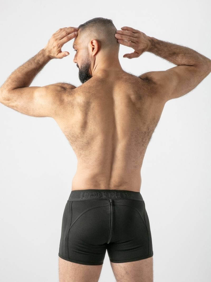 Man wearing black underwear against a white background