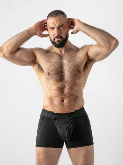 Man wearing black underwear against a white background