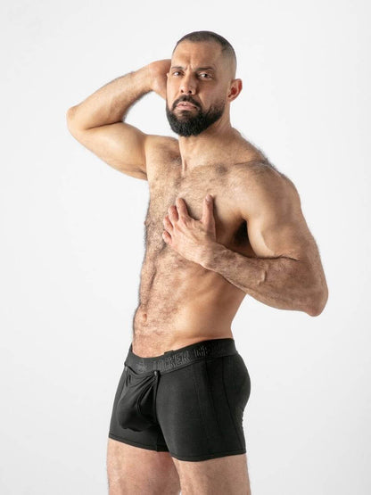 Man wearing black underwear against a white background