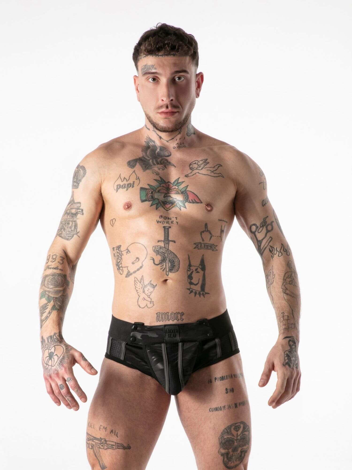 Man wearing black underwear with tattoos on a white background