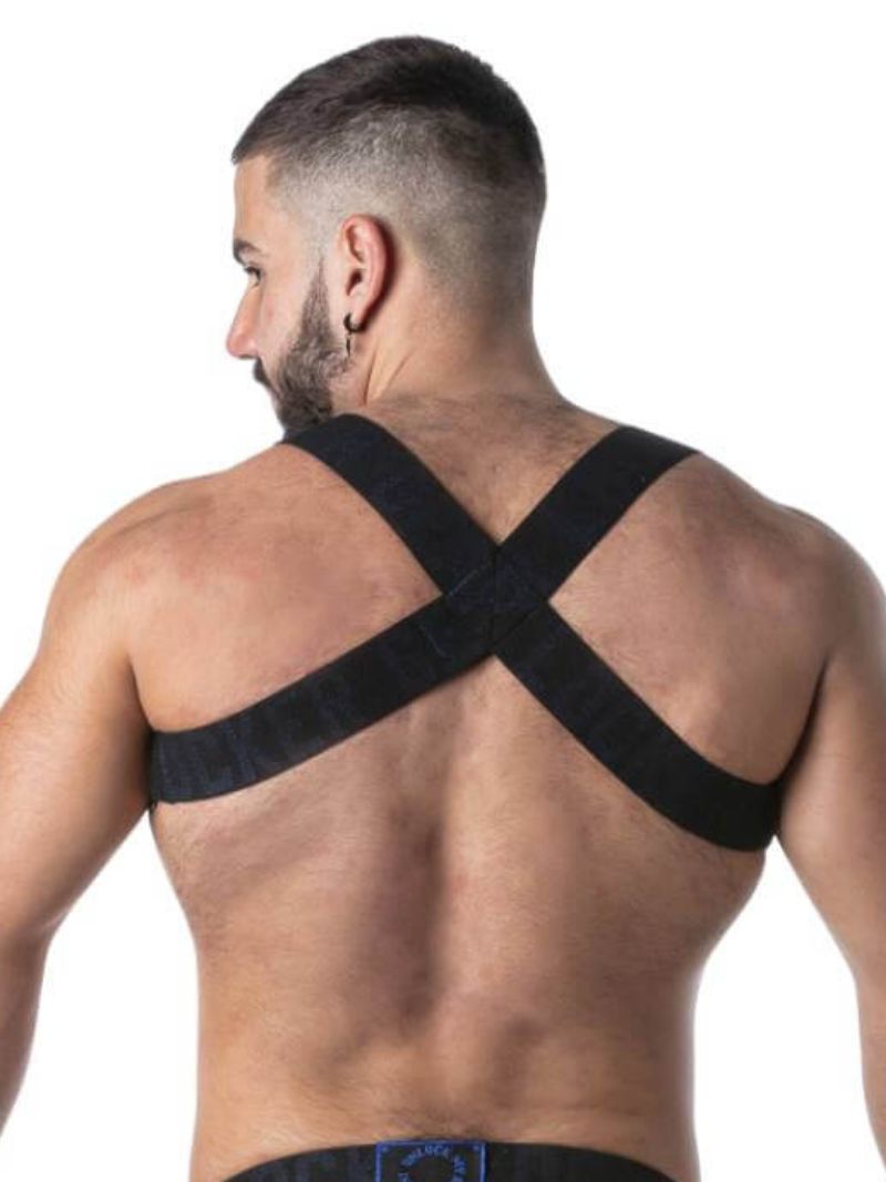 Man wearing a black back support brace on a white background