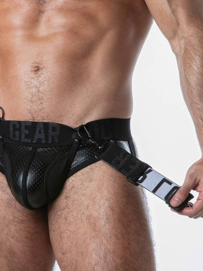 Black harness worn by a person on a plain background