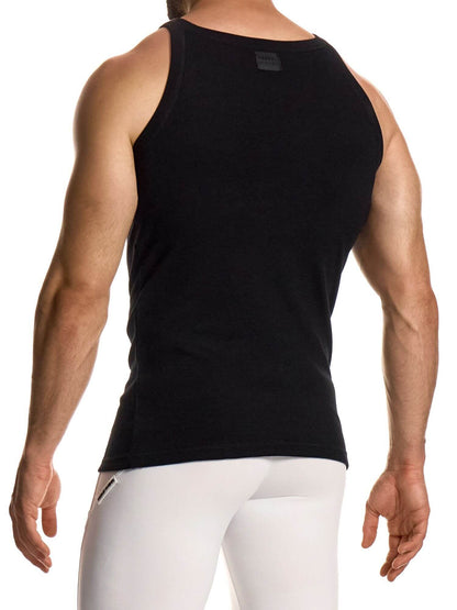Person wearing a black tank top and white pants on a white background
