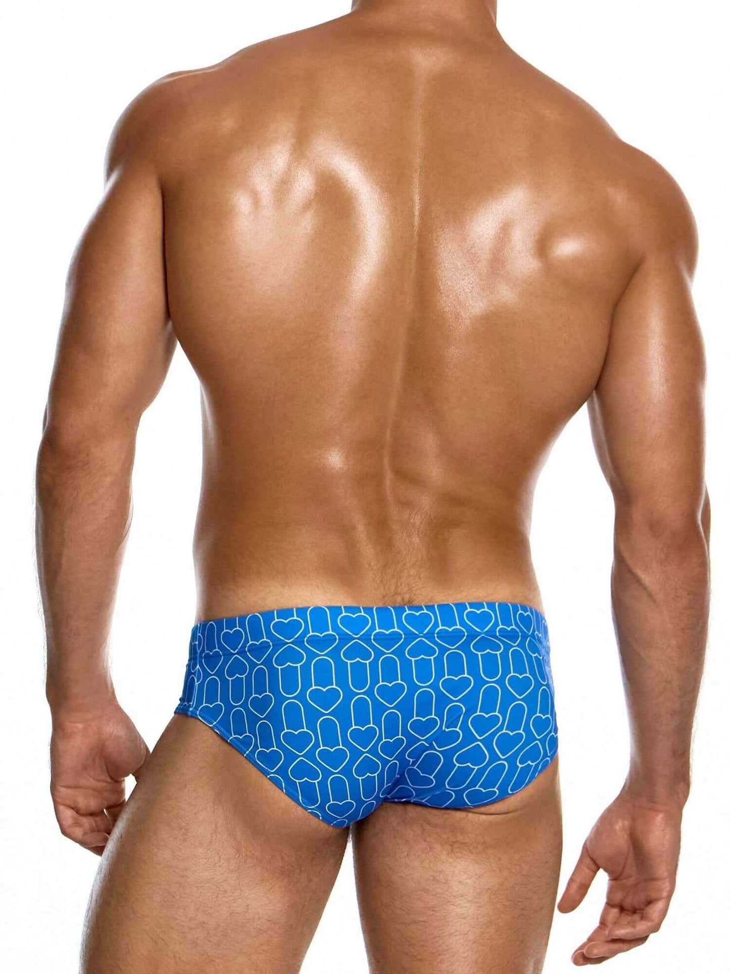 Man wearing blue swim briefs with a geometric pattern on a white background