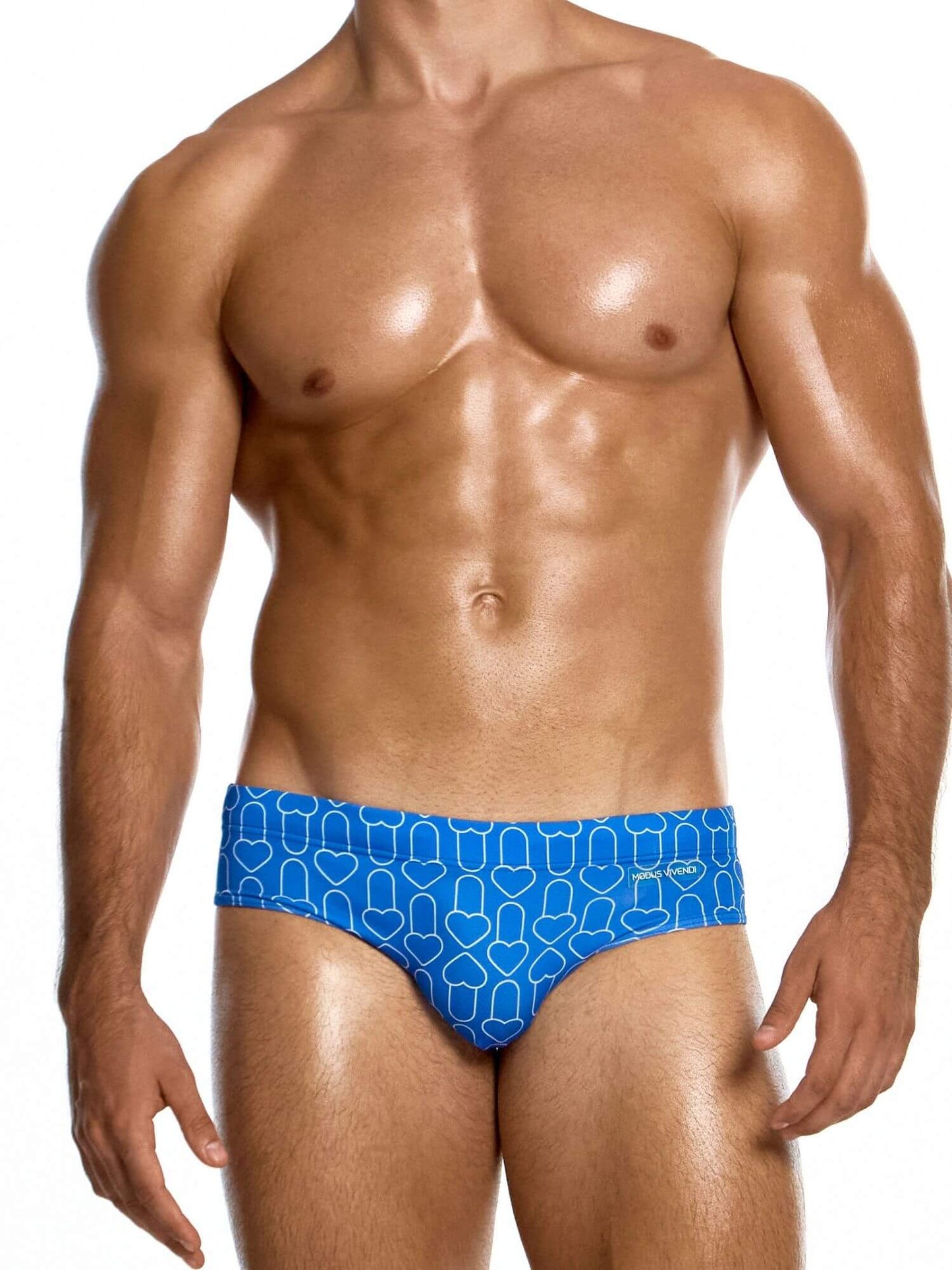 Man wearing a blue patterned swim brief on a white background