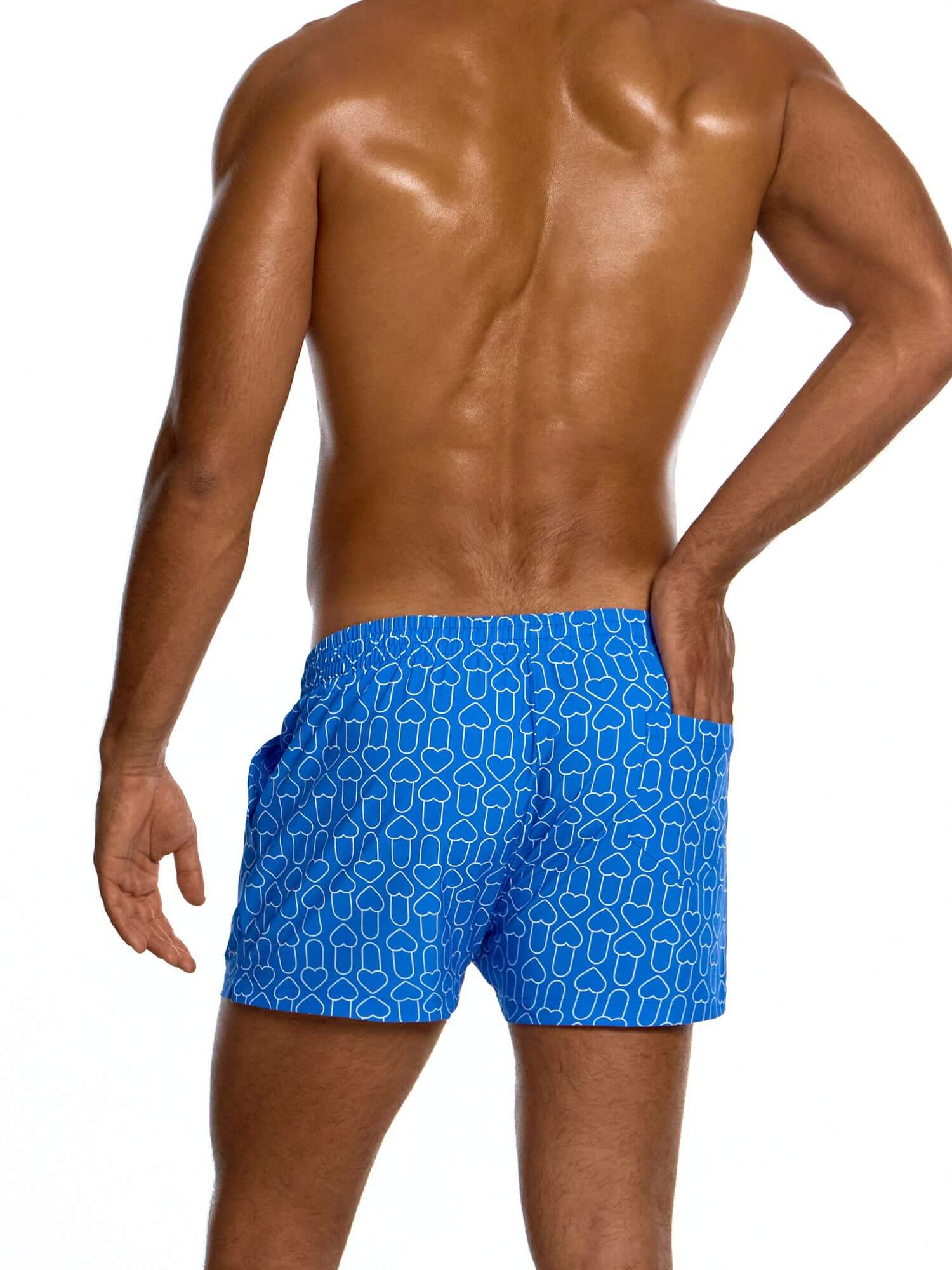 Man wearing blue swim shorts with a geometric pattern on a white background