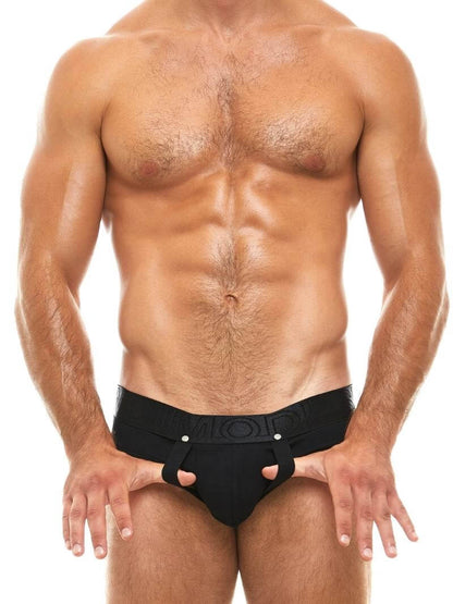 A model wearing gray Modus Vivendi Double Boost briefs that feature a bold all-over color with branding, pouch lifting straps, and external elasticated bum lifting straps.