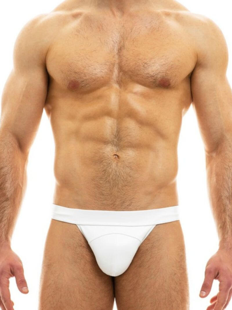 Man wearing a white thong against a white background