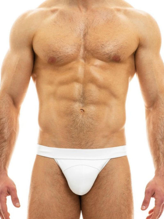 Man wearing a white thong against a white background