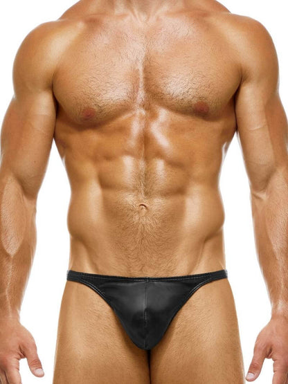 A red leather thong with a low-rise waist, featuring a contoured pouch and a metallic cutout tag on the back.