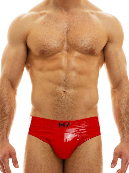 A man wearing a blue, shiny, bottomless PVC vinyl brief with an elasticated waistband and MV branding on the front.