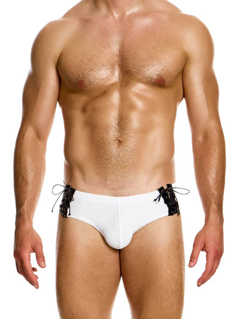 This image features the MODUS VIVENDI Boudoir Lace-Up Swimming Brief, modeled in smooth black fabric with shiny corset-style lace-up sides. The swim brief displays an adjustable lace-up tie string on high-shine glossy vinyl at the side panels, adding a distinctive and attractive detail to its design.