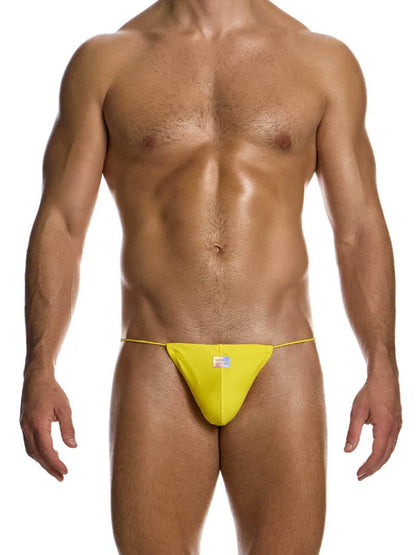 A male model wearing a yellow or mint green swimwear tanga with side tie strings and a shiny holographic Modus Vivendi logo.
