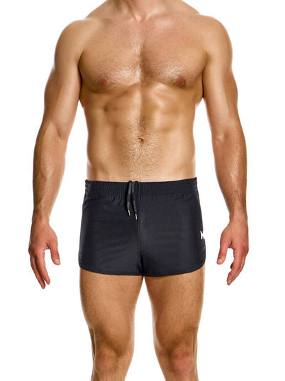 A man wearing blue jogging-style gym shorts with a drawstring waist.
