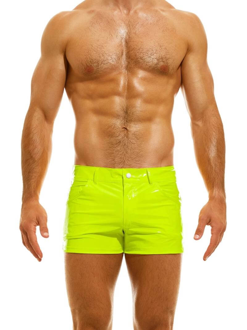 A man wearing red PVC vinyl 5 pocket shorts with a zip-up fly, button fastening, belt loops, and a thermo logo on the back pocket.