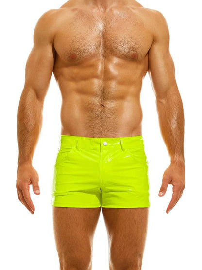 A man wearing red PVC vinyl 5 pocket shorts with a zip-up fly, button fastening, belt loops, and a thermo logo on the back pocket.