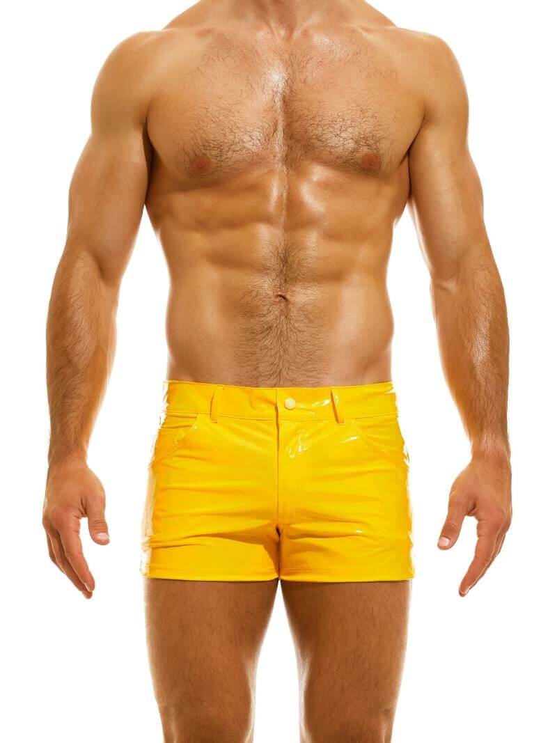A man wearing red PVC vinyl 5 pocket shorts with a zip-up fly, button fastening, belt loops, and a thermo logo on the back pocket.