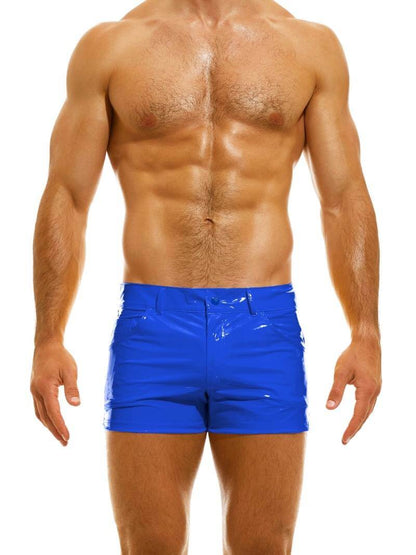 A man wearing red PVC vinyl 5 pocket shorts with a zip-up fly, button fastening, belt loops, and a thermo logo on the back pocket.