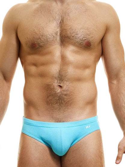 This image displays the MODUS VIVENDI Peace Classic Brief, modeled in a striking neon blue color. The briefs are designed with a low-rise waistband that ensures a modern and comfortable fit.
