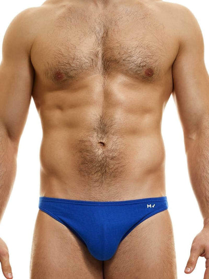 This image features the MODUS VIVENDI Peace low-cut mini brief, showcased in a striking neon blue color. The brief is designed with a super low-rise elastic waist and high-cut legs, creating a modern and flattering silhouette.